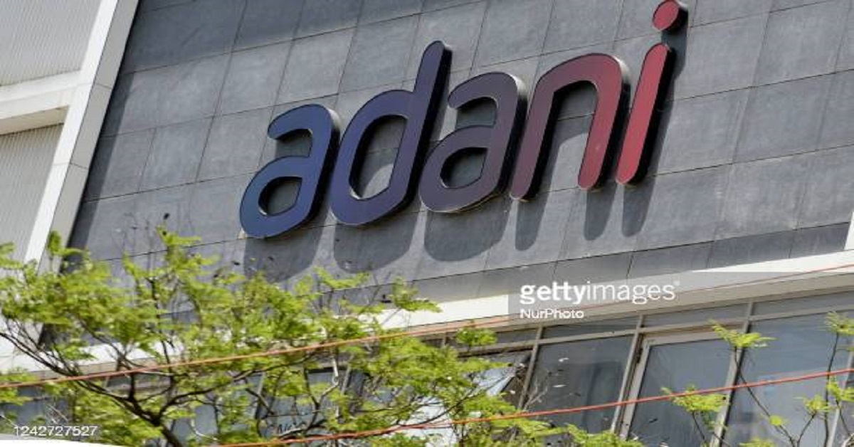 Adani Signage imprinted on its building with a lush green cover at the forefront